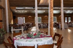 a large room with tables and chairs set up for a formal dinner or party in the center