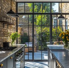 a kitchen with an open glass door leading to the outside