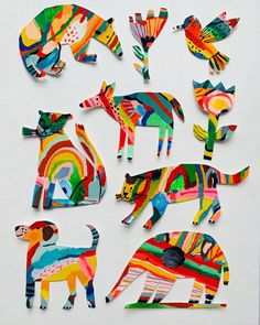 paper cut animals are arranged on a white surface with colorful colors and shapes in the shape of an animal