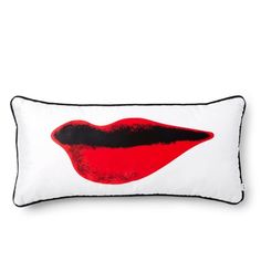 a white pillow with red lips on the front and black trim around the edges, against a white background