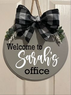 a welcome sign hanging from the side of a door that says, welcome to sarah's office