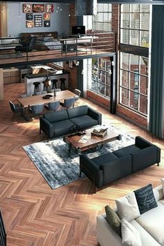 a living room filled with lots of furniture and large open floor space above it's wooden floors