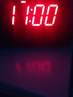 a red digital clock sitting on top of a table