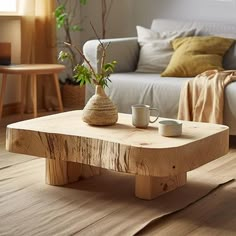 a wooden coffee table sitting on top of a hard wood floor next to a couch