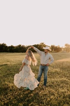 a man and woman dancing in a field