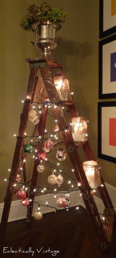 a christmas tree made out of an old ladder with lights and ornaments on it, sitting in the corner of a room