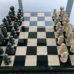 a chess board with black and white pieces on it