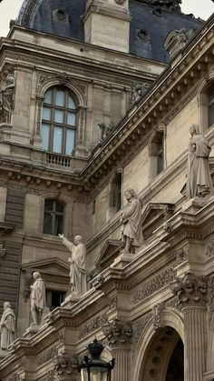 an old building with statues on the front