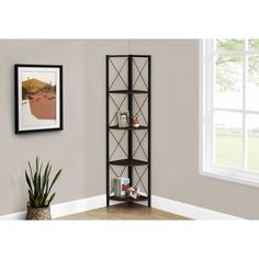 a tall bookcase with four shelves in front of a window next to a potted plant