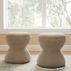 two stools sitting on top of a carpet covered floor next to a large window