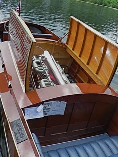 the engine compartment of a wooden boat on water