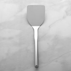 a white spatula sitting on top of a marble counter