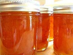 three jars filled with liquid sitting on top of a table