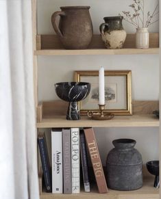 some books and vases are on the shelves