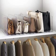 a row of purses and handbags hanging on a rack