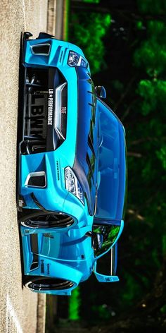 a blue sports car parked on the side of a road