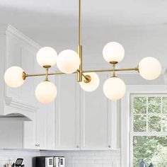 an image of a kitchen setting with lights hanging from the ceiling and on the counter