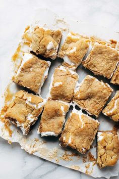 several pieces of dessert sitting on top of a piece of parchment paper