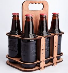 six beer bottles in a wooden holder