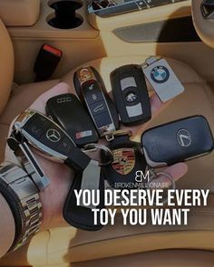 someone is holding their car keys in the back seat and it says, you deserve every toy you want