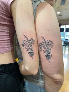 two women with matching tattoos on their arms