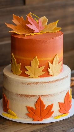 a multi layer cake decorated with fall leaves