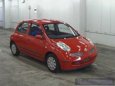 a small red car parked in a garage