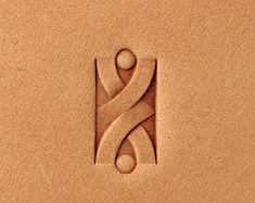 the logo is made out of sand and has a stylized figure on it's side