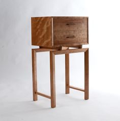 a small wooden table with drawers on it