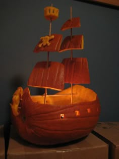 a carved wooden model of a boat on display