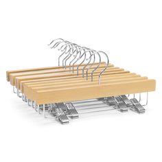 a bunch of wooden clothes hangers with metal clips attached to them on a white background