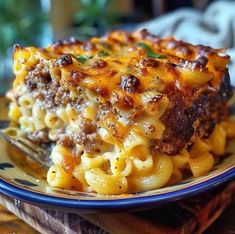 a close up of a plate of food with macaroni and cheese on it