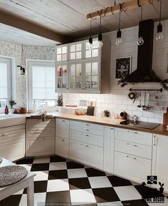 a black and white checkered floor in a kitchen with lots of counter top space