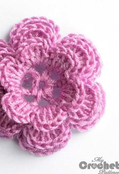 two crocheted pink flowers sitting on top of each other