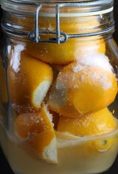 a glass jar filled with lemons and sugar