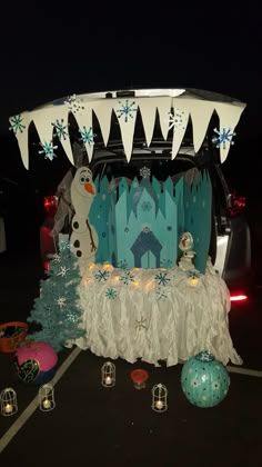 the back of a car decorated for christmas with snowmen and ice princess decorations on it