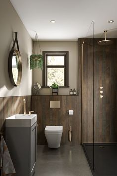 a bathroom with a toilet, sink, and shower stall in it's corner