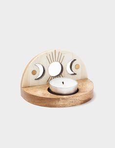 the moon and phases candle holder is made out of wood, with two candles in it