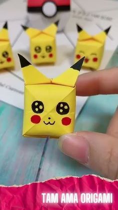 someone is holding up some origami pokemons