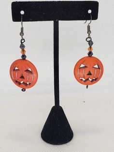 Ready to show off your Halloween spirit? This is the perfect piece to let the world know it's time to get spooky! These drop earrings  are approximately 1 inch and feature a large orange Jack-O'-Lantern bead with small black and orange crystals This piece screams Halloween, but has just enough subtlety if you can't exactly scream at the office (but it will still loudly whisper Halloween). The best part? Not only are these earrings 100% Halloween, but Jack-O'-Lanterns can absolutely work throughout the fall season! Pairs perfectly with matching necklace found here: https://www.etsy.com/listing/838734620 Spooky Nickel-free Earrings For Halloween, Halloween Themed Pierced Jewelry, Pierced Themed Jewelry For Halloween, Spooky Pierced Earrings For Halloween, Spooky Handmade Earrings For Halloween, Novelty Halloween Pierced Earrings, Spooky Handmade Halloween Earrings, Witchy Halloween Earrings Adjustable, Novelty Orange Earrings For Halloween