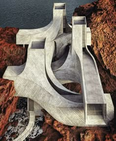 an aerial view of a concrete structure on top of a rocky cliff next to the ocean