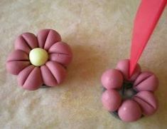 two pink flower shaped objects sitting on top of a table