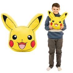 a man holding a pillow with a pikachu face on it next to an inflatable pillow