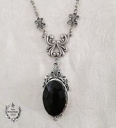 A beautiful and romantic classic gothic necklace featuring a black or red gem Gothic Pendant Necklace For Party, Victorian Metal Necklace For Party, Victorian Metal Necklaces For Party, Ornate Black Metal Necklace, Gothic Pendant Necklace With Jewels, Gothic Metal Necklaces With Jewels, Gothic Handmade Formal Necklace, Handmade Gothic Necklaces For Formal Occasions, Handmade Gothic Necklace For Formal Occasions