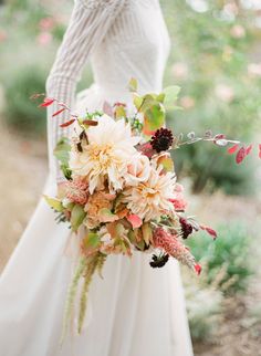 a bride holding a bouquet of flowers in her hand