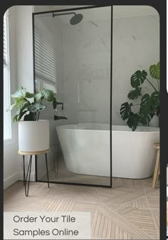 a white tub sitting next to a plant in a bathroom with the words order your tile samples online