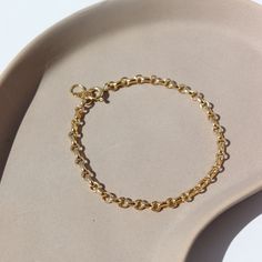 Picture a sleek and elegant gold bracelet, designed with minimalism in mind. It features a delicate chain crafted from shimmering 14k gold fill, offering a subtle yet luxurious glow. This piece embodies sophistication and refinement, perfect for adding a touch of timeless elegance to any ensemble. DETAILS14k gold fill Hypoallergenic, water proof, and nickel free To determine your wrist size, use a tape measure or ribbon around your wrist, then measure against a ruler. Modern Everyday 14k Gold Filled Bracelet, Minimalist Tarnish Resistant Recycled Gold Bracelet, Minimalist 14k Gold Filled Bracelet With Adjustable Chain, Minimalist Adjustable Recycled Gold Bracelets, Adjustable Minimalist Bracelets In Recycled Gold, 14k Yellow Gold Charm Bracelet For Everyday, Minimalist Adjustable Bracelets In Recycled Gold, Dainty Yellow Gold Bracelets Made From Recycled Gold, Everyday 14k Yellow Gold Charm Bracelet