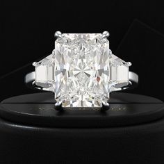 a cushion cut diamond ring with three baguets