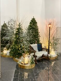 christmas trees are lined up on the floor in front of a bench and lampposts