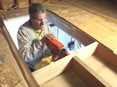 a man is working on some wood with a drill